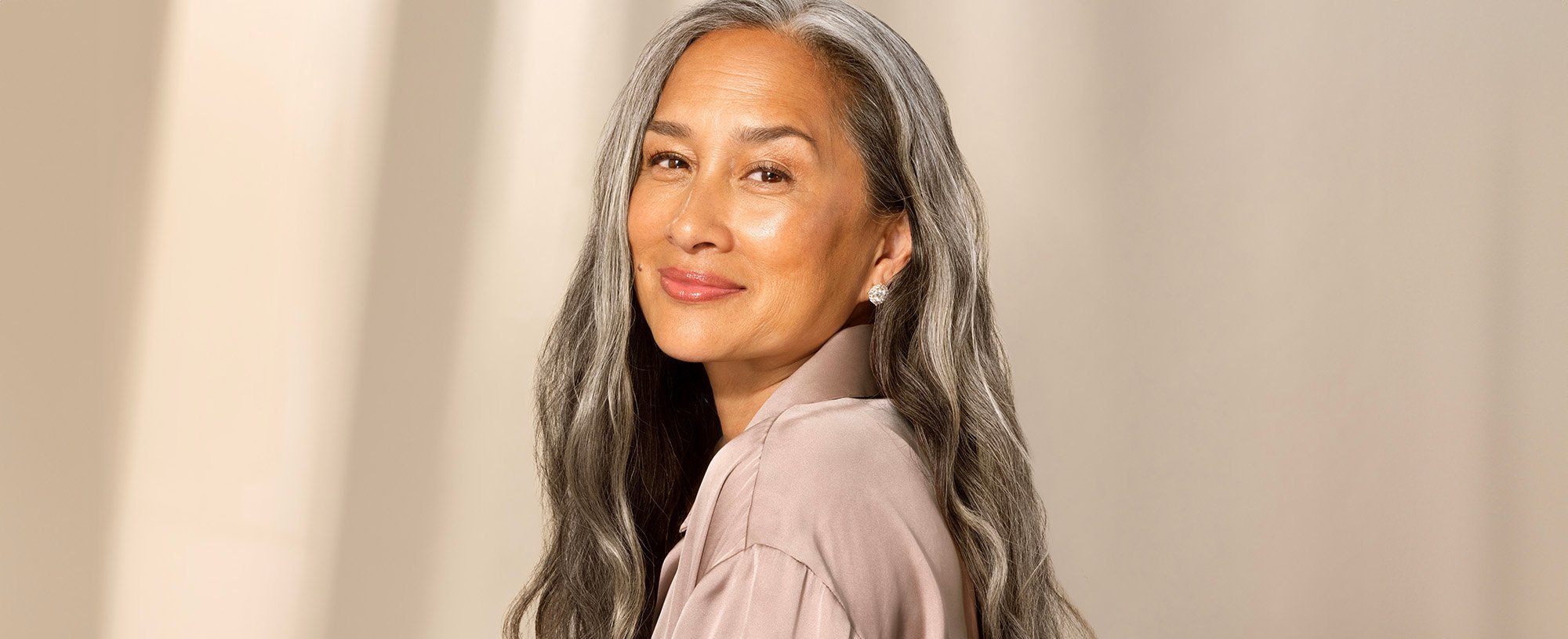 Smiling woman with long hair.